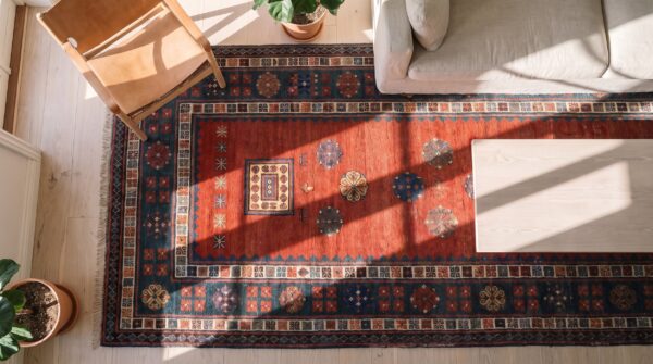 Coral antique long and narrow caucasian kazak knotted wool pile rug 2 Coral antique long and narrow caucasian kazak knotted wool pile rug (sku 21082) - styled overhead view