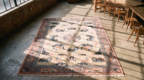 Antique wool coral / salmon pink hand knotted pile rug (sku 22846) - styled overhead view