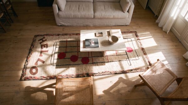 Cream color antique american folk art musical notes design hooked rug 2 Cream color antique american folk art musical notes design hooked rug (sku 20505) - styled overhead view