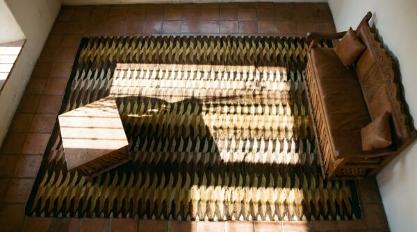 Dazzling geometric design antique native american navajo earth tone rug 2 Dazzling geometric design antique native american navajo earth tone rug (sku 23767) - styled overhead view
