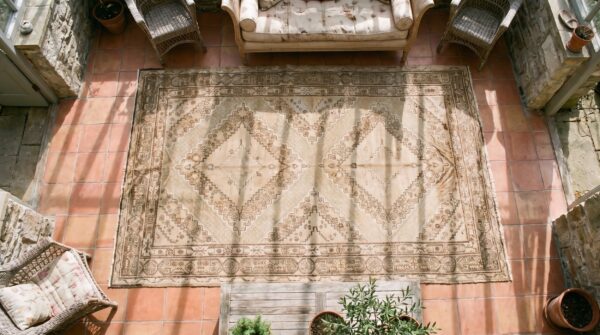 Antique east turkestan wool pile cream color hand knotted khotan rug (sku 20047) - styled overhead view
