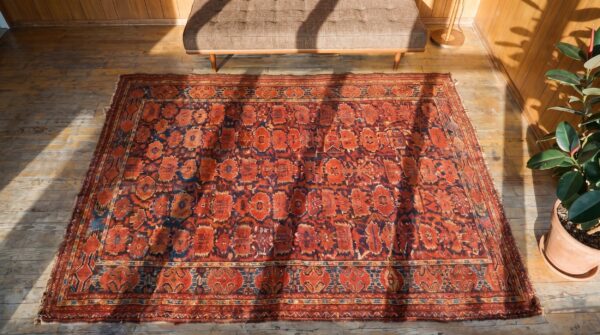 Antique ersari - beshir persian knotted coral rug (sku 19957) - styled overhead view
