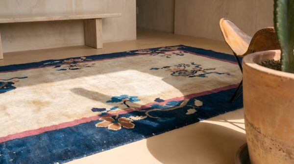 Floral antique hand knotted pile ivory beige cream white 1920s rectangle wool rug (sku 23219) - in-room detail