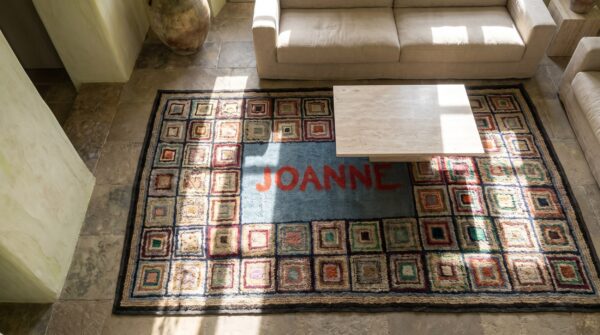 Folk art pattern antique american hooked rug signed joanne (sku 17474) - styled overhead view