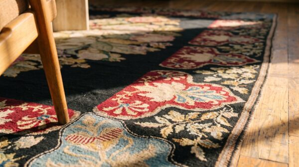 Antique french needlepoint carpet 5'2"×8'8" black with roses, raspberry border, circa 1890 (sku 19052) - in-room detail
