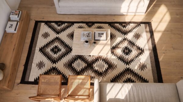 Antique geometric pattern native american flat weave rug (sku 25065) - styled overhead view