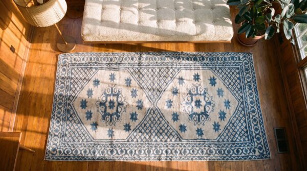 Geometric star pattern antique white and blue color cotton agra rug 2 Geometric star pattern antique white and blue color cotton agra rug (sku 20368) - styled overhead view