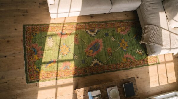 Antique green turkish oushak hallway runner rug (sku 23289) - styled overhead view