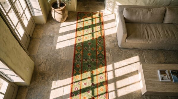 Antique indian agra green tribal geometric hallway runner rug (sku 19976) - styled overhead view