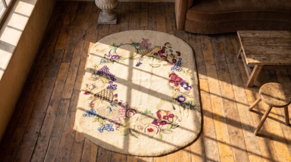 Antique ivory open field small oval american hooked folk art rug 2 Antique ivory open field small oval american hooked folk art rug (sku 20546) - styled overhead view