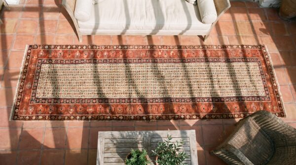 Ivory antique tribal allover late 19th century persian malayer hallway runner rug (sku 22338) - styled overhead view