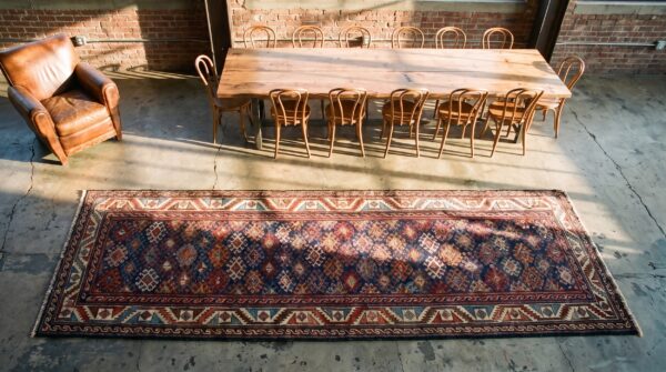 Antique kurdish blue wool hallway runner rug (sku 21542) - styled overhead view