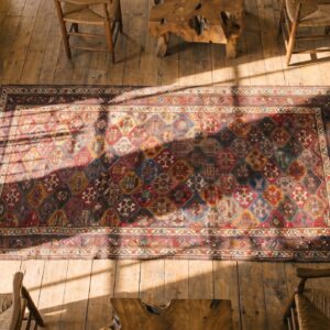 Antique Kurdish Long and Narrow Wool Rug (SKU 18209) - styled overhead view
