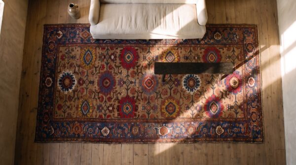 Antique large bakhtiari persian geometric knotted rug (sku 24092) - styled overhead view