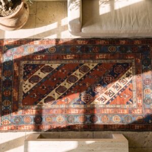 Antique Late 19th Century Tribal Geometric Caucasian Kazak Paisley Pattern Hallway Runner Rug (SKU 18731) - styled overhead view