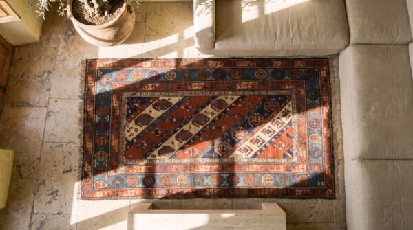 Antique late 19th century tribal geometric caucasian kazak paisley pattern hallway runner rug 2 Antique late 19th century tribal geometric caucasian kazak paisley pattern hallway runner rug (sku 18731) - styled overhead view