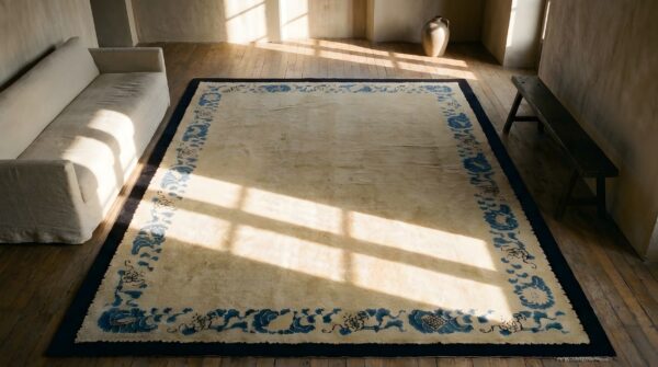Minimalist open cream color field antique 1900's peking chinese rug (sku 24754) - styled overhead view