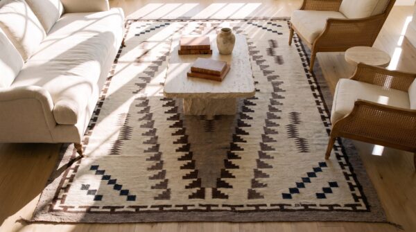 Antique navajo native american medallion white and black color flatweave rug (sku 23616) - styled overhead view