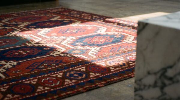 Antique red caucasian moghan tribal rug 7 Antique red caucasian moghan tribal rug (sku 21504) - in-room detail