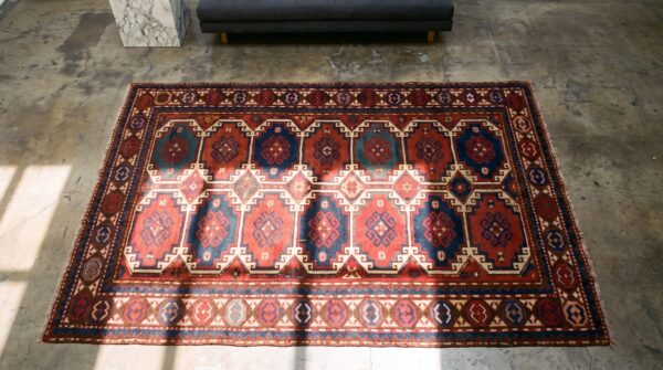 Antique red caucasian moghan tribal rug 2 Antique red caucasian moghan tribal rug (sku 21504) - styled overhead view