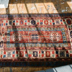 Antique Red Caucasian Tribal Geometric Medallion Kazak Rug (SKU 19575) - styled overhead view