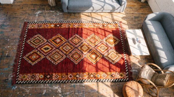 Antique red julkhir uzbekistan knotted rug 2 Antique red julkhir uzbekistan knotted rug (sku 20050) - styled overhead view
