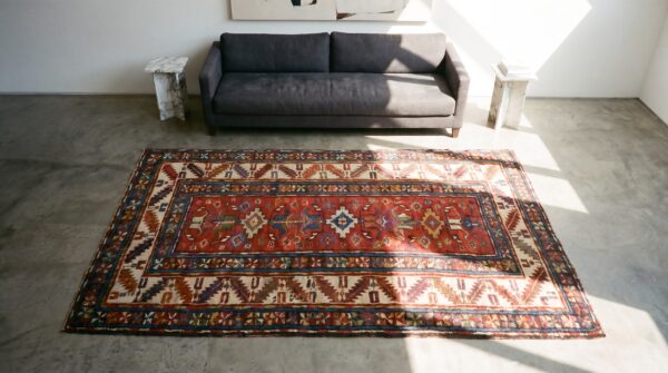 Red rustic antique allover tribal geometric pattern caucasus kazak wool pile rug 2 Red rustic antique allover tribal geometric pattern caucasus kazak wool pile rug (sku 19040) - styled overhead view