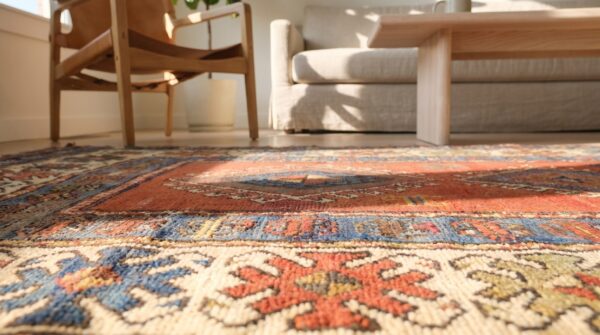 Red rustic antique tribal geometric pattern caucasian kazak rug (sku 17766) - in-room detail
