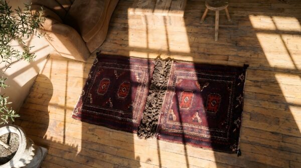 Antique red tribal geometric bold central asian tekke rug saddle bag (sku 23000) - styled overhead view