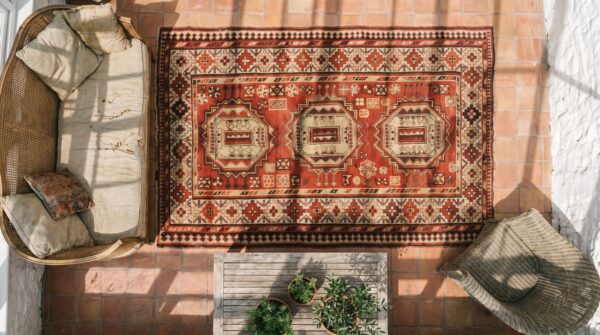 Red antique tribal geometric caucasian karabagh knotted wool pile rug 2 Red antique tribal geometric caucasian karabagh knotted wool pile rug (sku 18328) - styled overhead view