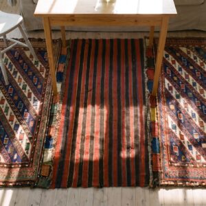 Red Tribal Geometric Antique Caucasian Soumak Saddle Rug (SKU 25256) - styled overhead view