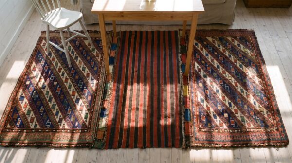Red tribal geometric antique caucasian soumak saddle rug 2 Red tribal geometric antique caucasian soumak saddle rug (sku 25256) - styled overhead view