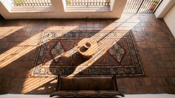 Red tribal geometric antique late 19th century caucasian soumak flatweave rug 2 Red tribal geometric antique late 19th century caucasian soumak flatweave rug (sku 24077) - styled overhead view