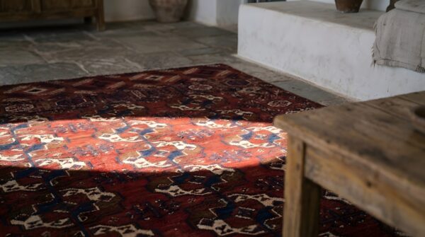 Red antique turkman tekke tribal geometric bokhara design rug (sku 22769) - in-room detail