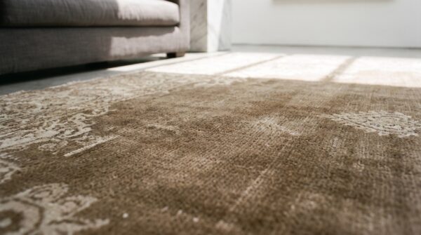 Room size neutral brown earth tone color antique agra area rug (sku 18283) - in-room detail