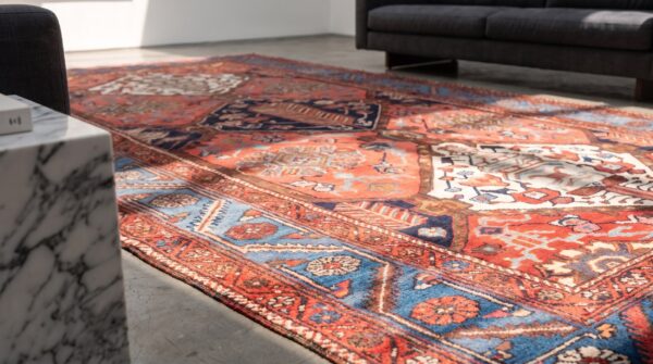 Rustic tribal geometric antique persian bakhtiari wool pile coral area rug 9 Rustic tribal geometric antique persian bakhtiari wool pile coral area rug (sku 21458) - in-room detail