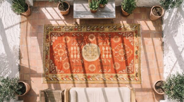 Antique rustic yellow color small size east turkestan wool pile khotan rug 2 Antique rustic yellow color small size east turkestan wool pile khotan rug (sku 20219) - styled overhead view