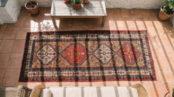 Antique serab persian brown 1930s hallway runner rug (sku 18541) - styled overhead view