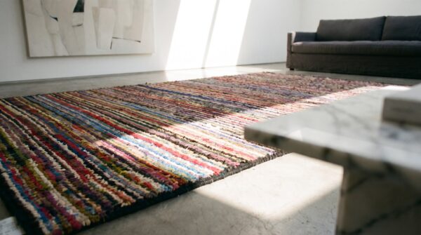 Small colorful stripped antique modernist american hooked area rug (sku 17661) - in-room detail