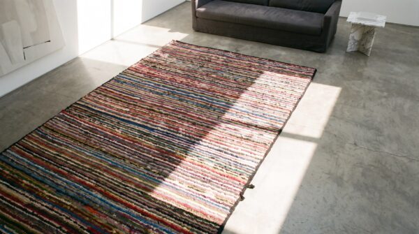 Small colorful stripped antique modernist american hooked area rug (sku 17661) - styled overhead view
