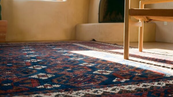 Small scatter size blue background antique tribal geometric persian baluch rug (sku 25435) - in-room detail