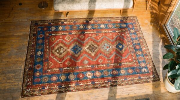 Small size red tribal geometric antique late 19th century caucasian kazak rug 2 Small size red tribal geometric antique late 19th century caucasian kazak rug (sku 18054) - styled overhead view