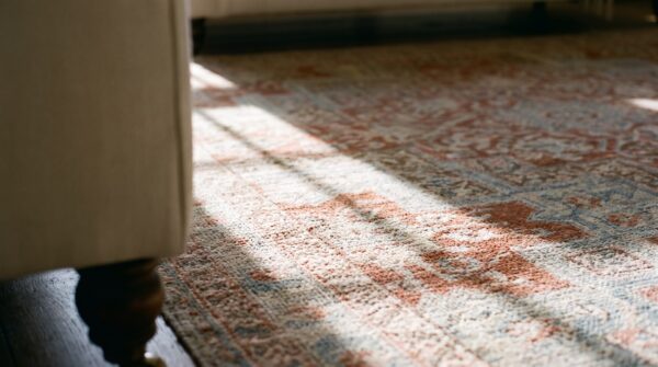Soft light coral antique tribal medallion design cotton agra rug 10 Soft light coral antique tribal medallion design cotton agra rug (sku 21743) - in-room detail
