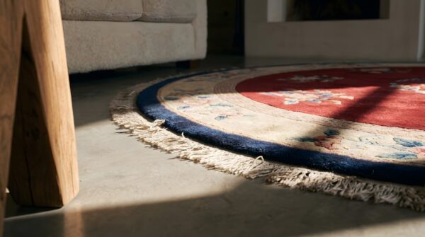 Antique solid red open field round chinese art deco rug (sku 22093) - in-room detail