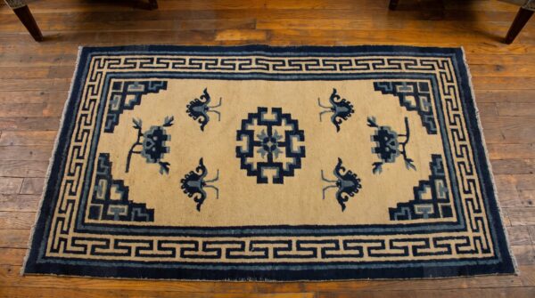 Antique swastika medallion pattern small scatter size mongolian rug (sku 21177) - styled overhead view