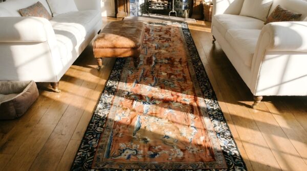 Antique textile small scatter size wool coral rug (sku 23944) - styled overhead view