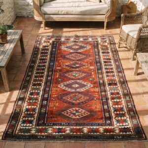 Antique Tribal Geometric Coral Caucasian Kazak Rug (SKU 18390) - styled overhead view