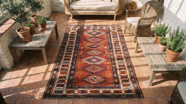 Antique tribal geometric coral caucasian kazak rug (sku 18390) - styled overhead view