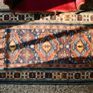 Antique Tribal Geometric Crab Design Border Caucasian Kuba Rug (SKU 24957) - styled overhead view