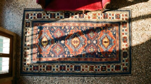 Antique tribal geometric crab design border caucasian kuba rug 2 Antique tribal geometric crab design border caucasian kuba rug (sku 24957) - styled overhead view